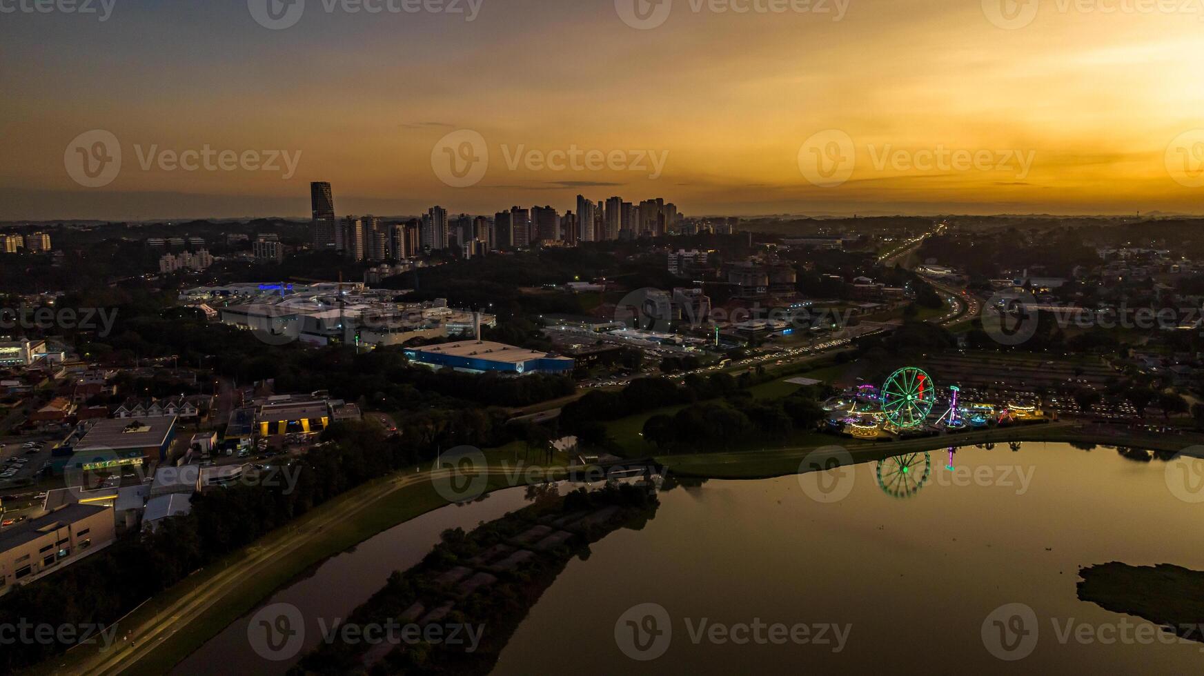 Curitiba in Parana, Brazil. Aerial View. Wonderful sunset with views of buildings and Tangua Park. Lake with reflection. photo