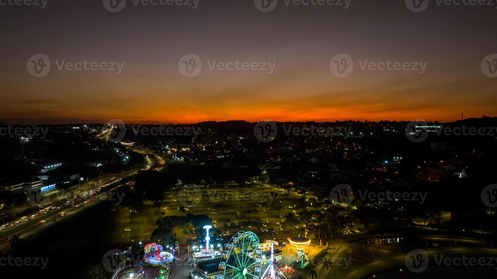 Curitiba in Parana, Brazil. Aerial View. Wonderful sunset with views of buildings and Tangua Park. Lake with reflection. photo