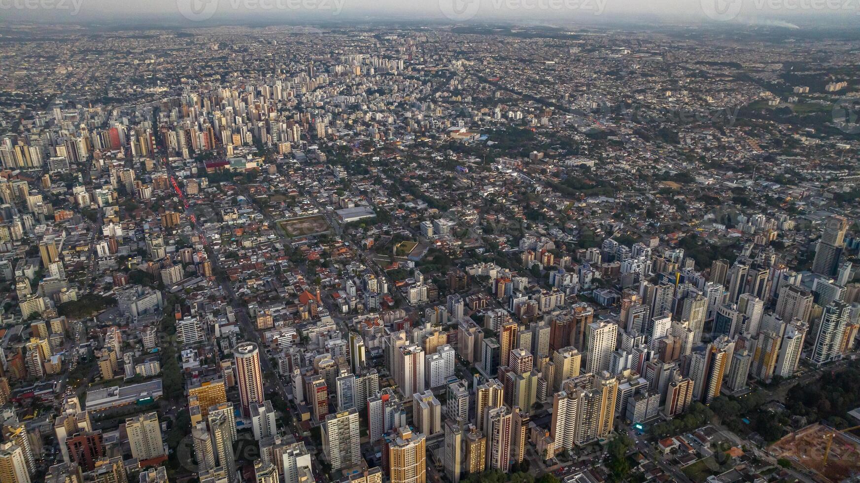 Curitiba in Parana, Brazil. Aerial View. Wonderful sunset with views of buildings and Tangua Park. Lake with reflection. photo