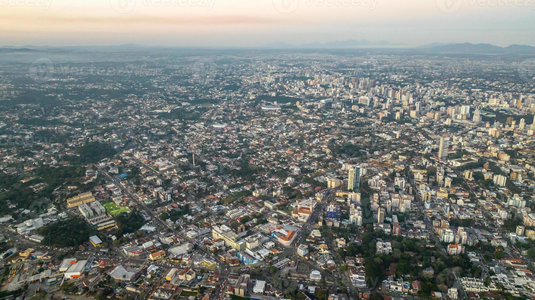 Curitiba in Parana, Brazil. Aerial View. Wonderful sunset with views of buildings and Tangua Park. Lake with reflection. photo