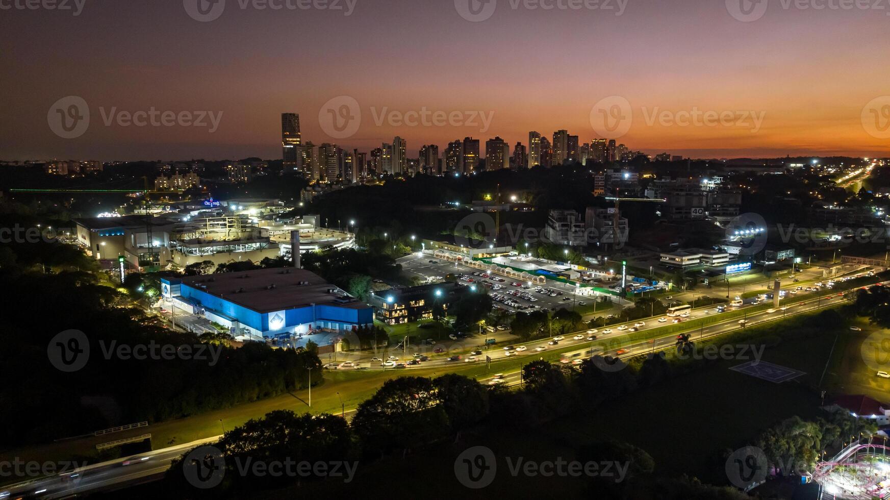 Curitiba in Parana, Brazil. Aerial View. Wonderful sunset with views of buildings and Tangua Park. Lake with reflection. photo