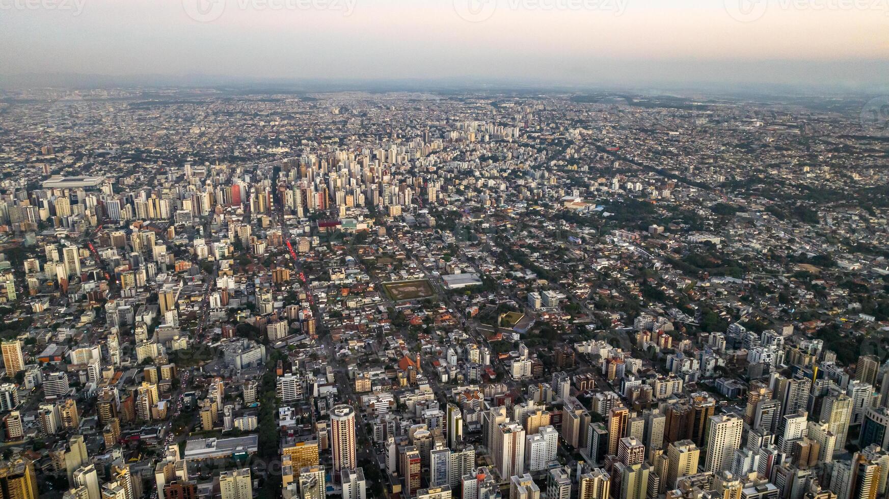 Curitiba in Parana, Brazil. Aerial View. Wonderful sunset with views of buildings and Tangua Park. Lake with reflection. photo