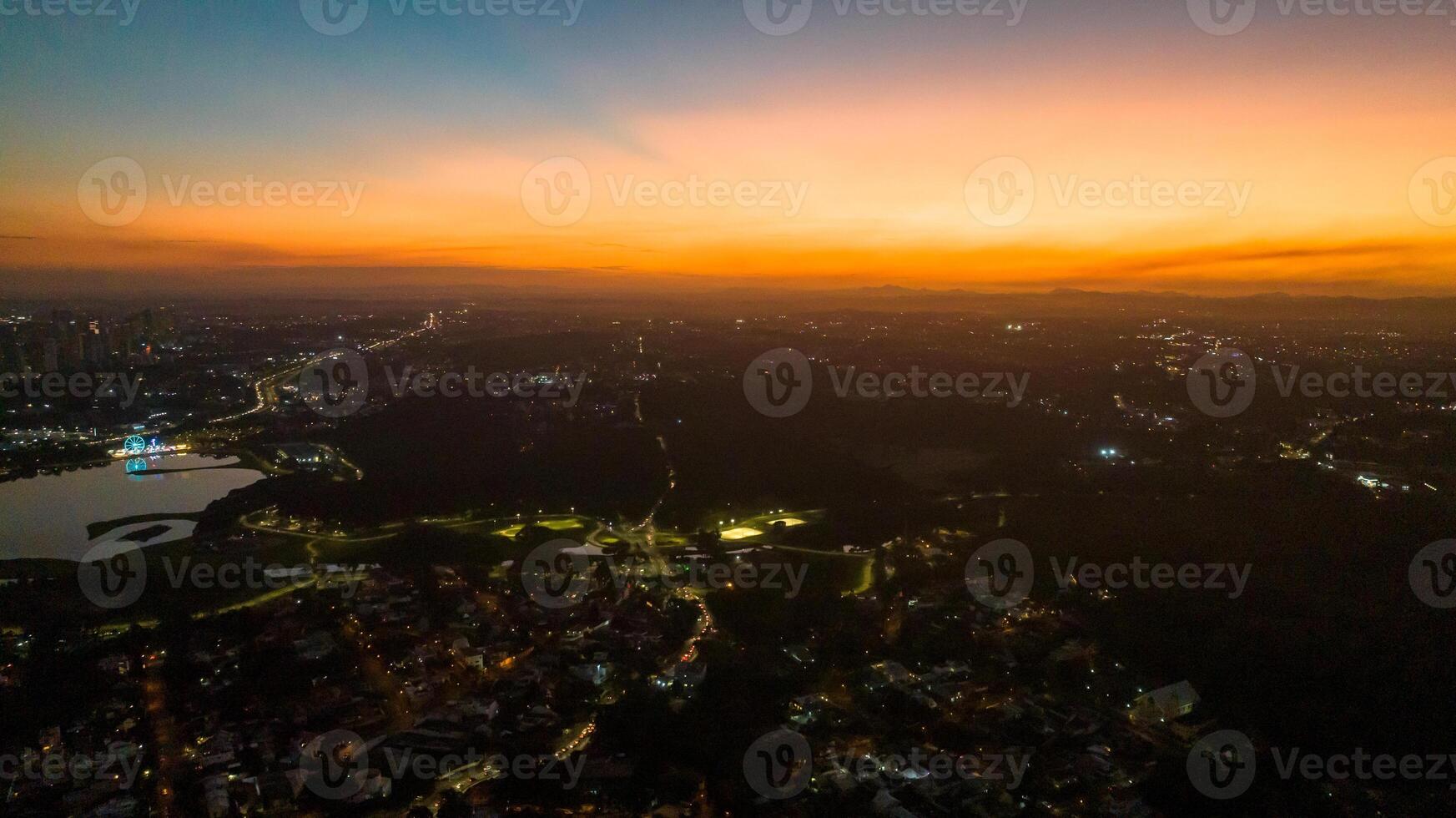 Curitiba in Parana, Brazil. Aerial View. Wonderful sunset with views of buildings and Tangua Park. Lake with reflection. photo