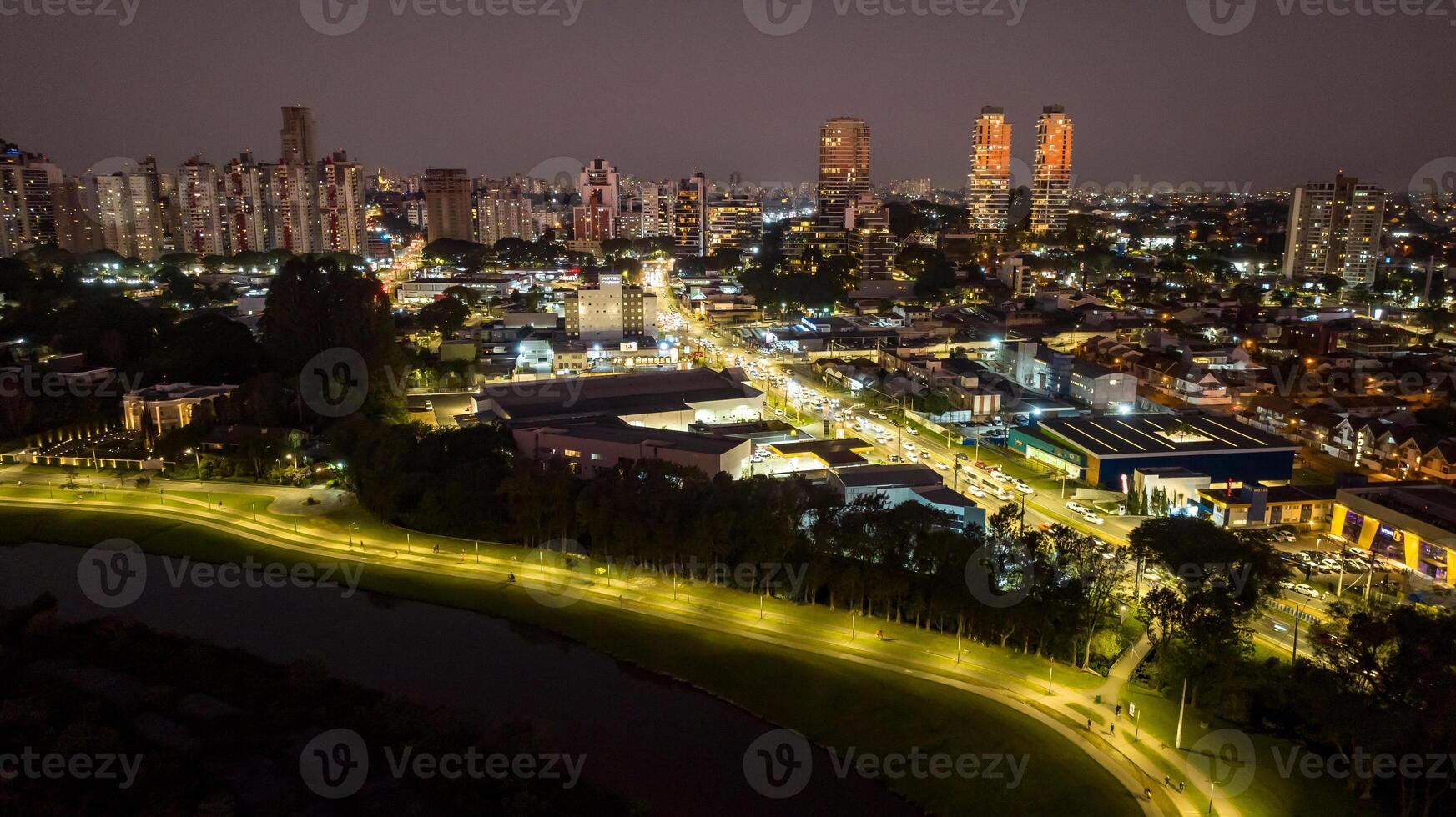 Curitiba in Parana, Brazil. Aerial View. Wonderful sunset with views of buildings and Tangua Park. Lake with reflection. photo