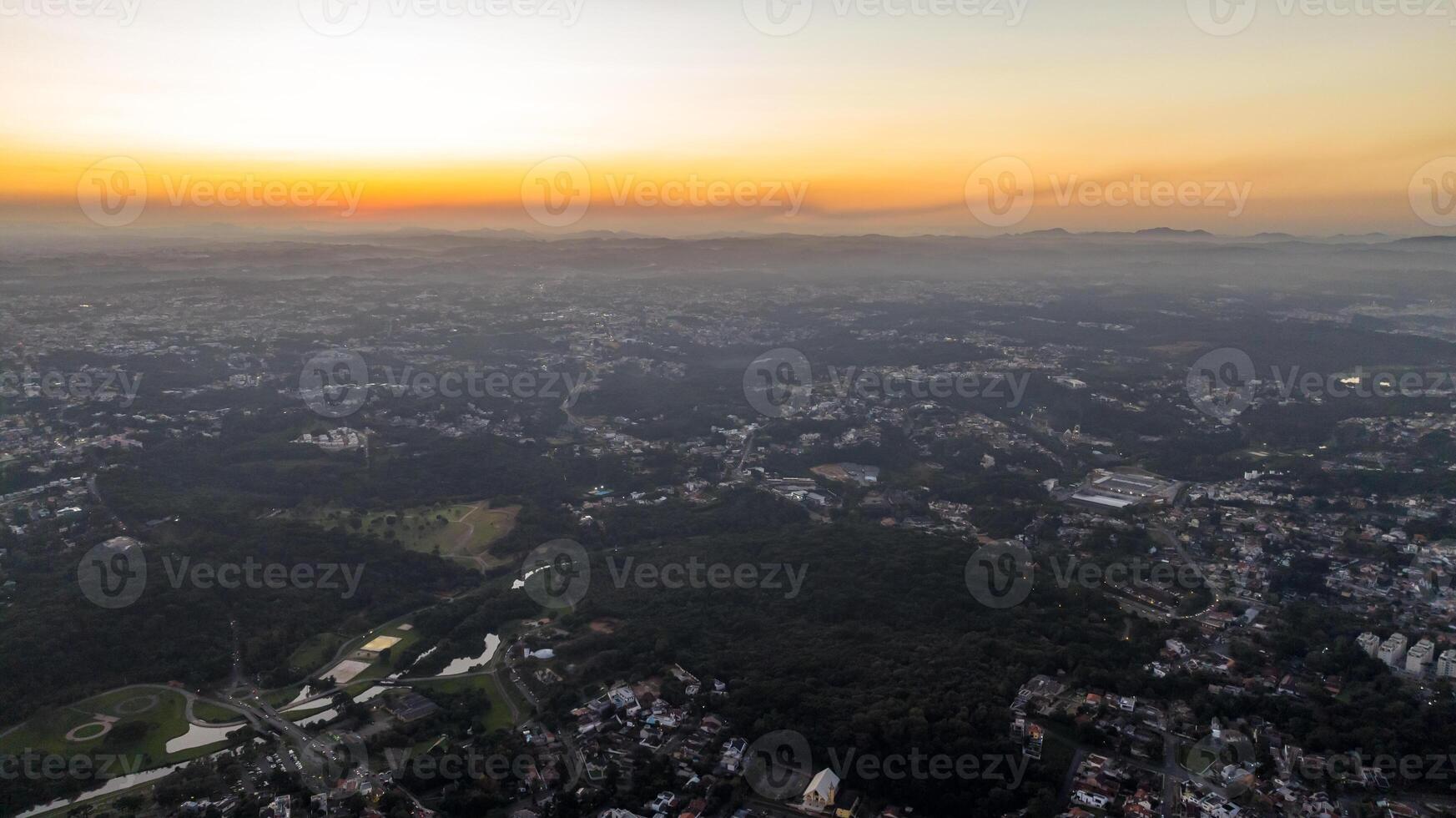 Curitiba in Parana, Brazil. Aerial View. Wonderful sunset with views of buildings and Tangua Park. Lake with reflection. photo