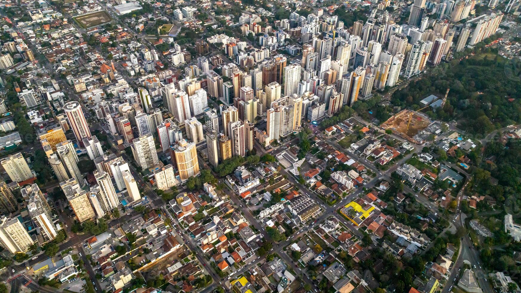 Curitiba in Parana, Brazil. Aerial View. Wonderful sunset with views of buildings and Tangua Park. Lake with reflection. photo