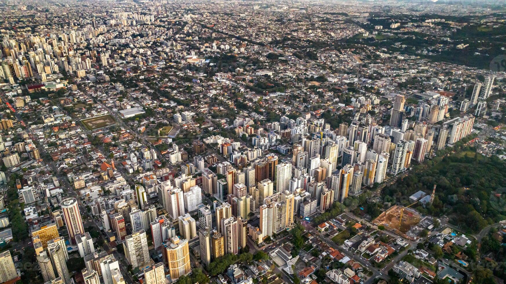 Curitiba in Parana, Brazil. Aerial View. Wonderful sunset with views of buildings and Tangua Park. Lake with reflection. photo