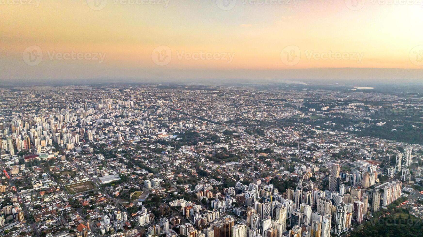 Curitiba in Parana, Brazil. Aerial View. Wonderful sunset with views of buildings and Tangua Park. Lake with reflection. photo