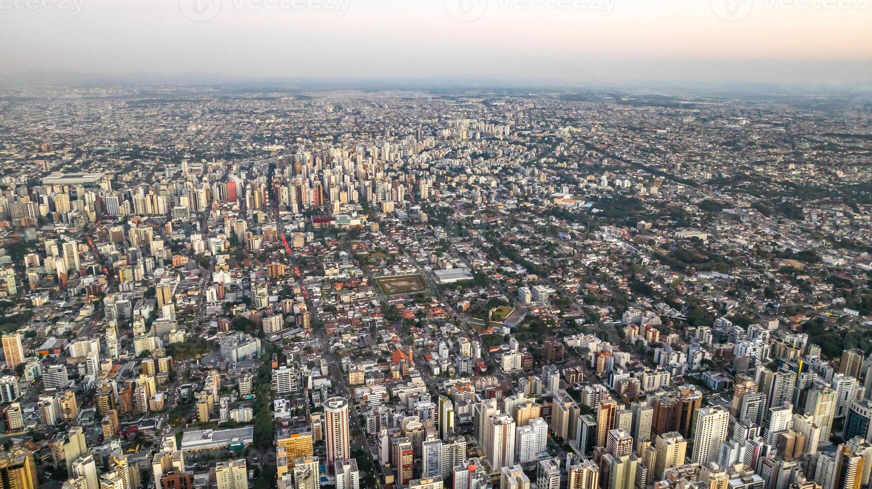 Curitiba in Parana, Brazil. Aerial View. Wonderful sunset with views of buildings and Tangua Park. Lake with reflection. photo