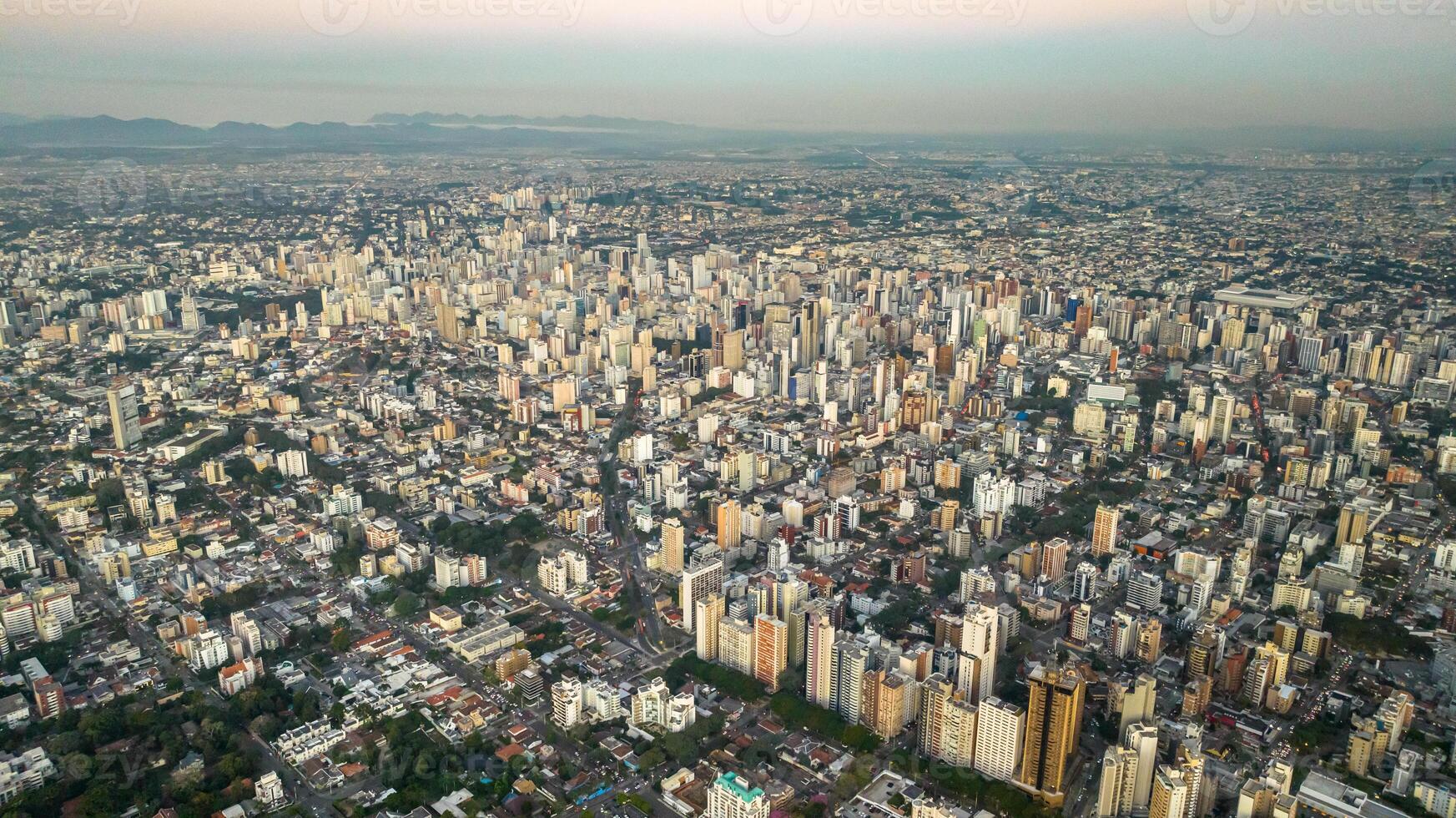 Curitiba in Parana, Brazil. Aerial View. Wonderful sunset with views of buildings and Tangua Park. Lake with reflection. photo