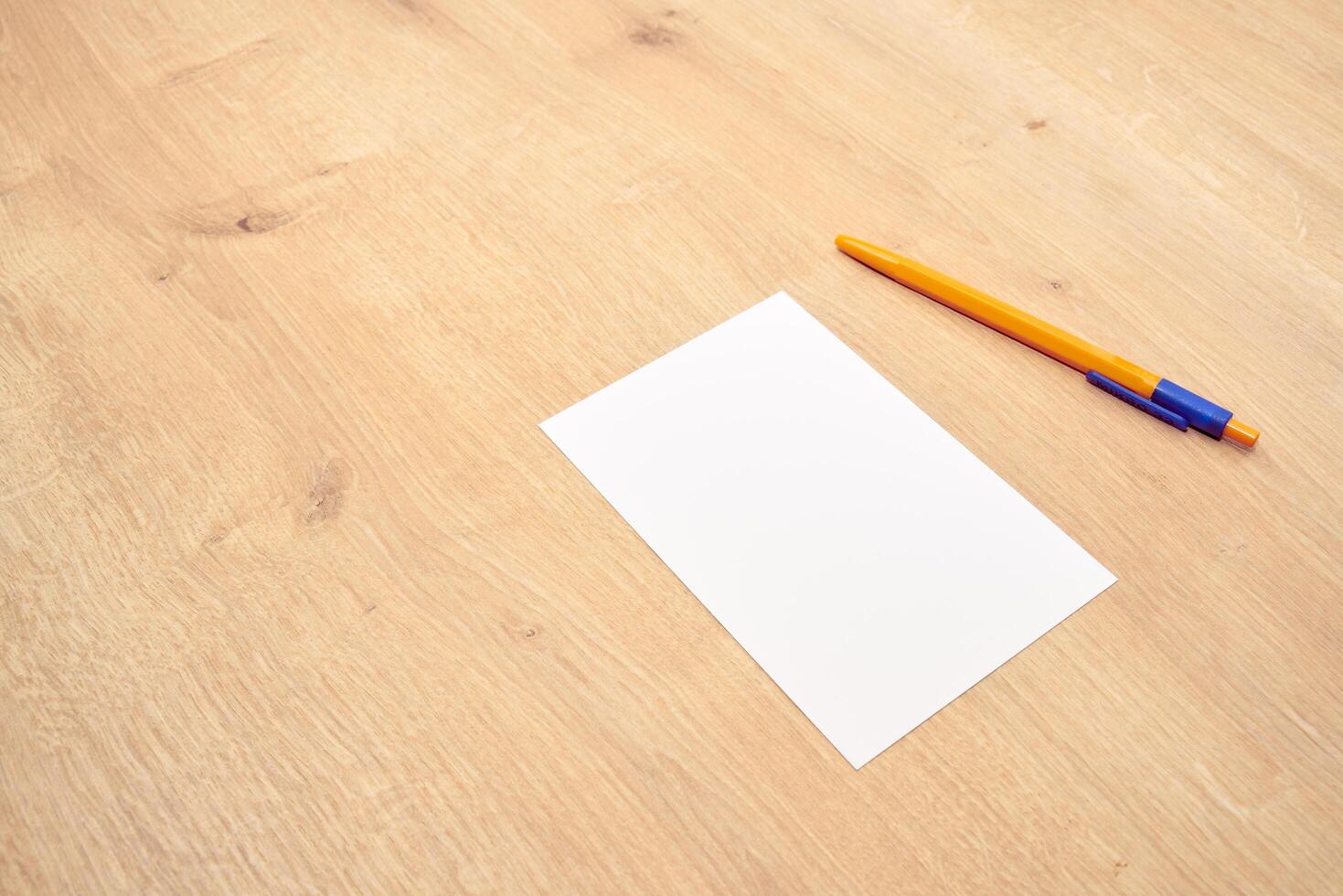 blank a 4 paper and a pen on a table photo