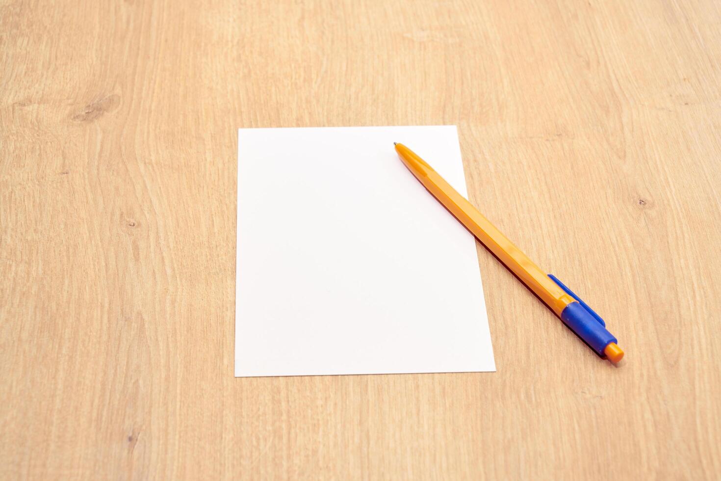 blank a 4 paper and a pen on a table photo