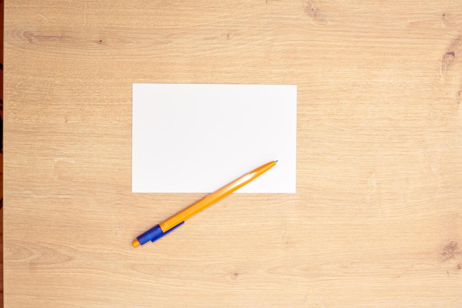blank a 4 paper and a pen on a table photo