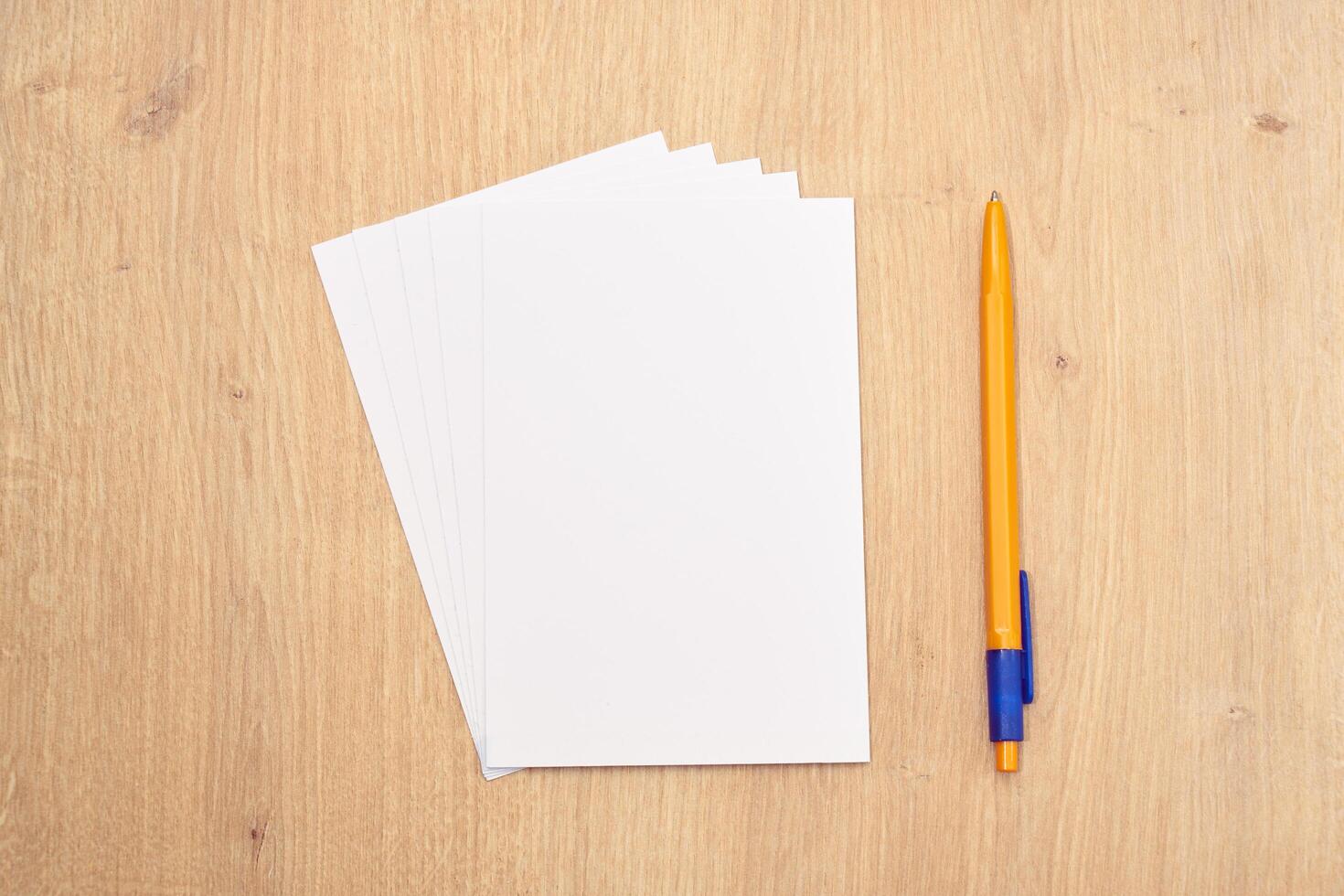 blank a 4 paper and a pen on a table photo