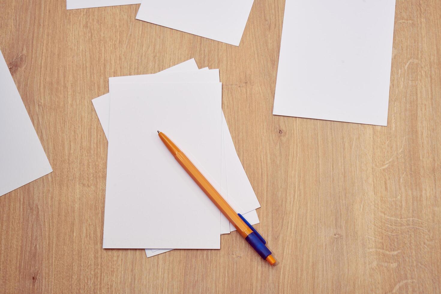 blank a 4 paper and a pen on a table photo