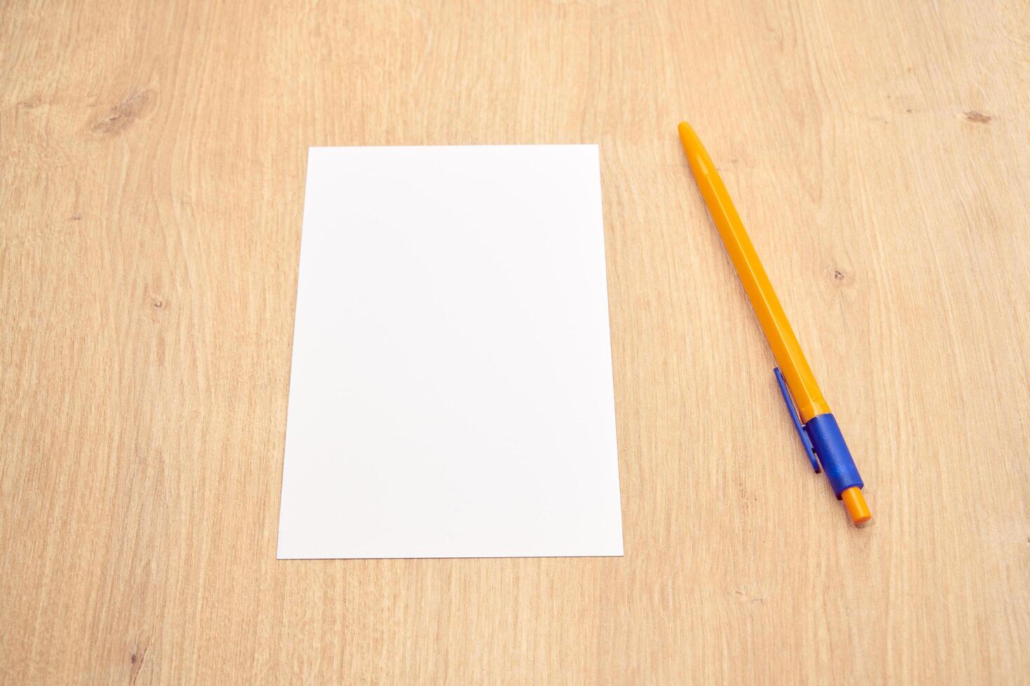 blank a 4 paper and a pen on a table photo