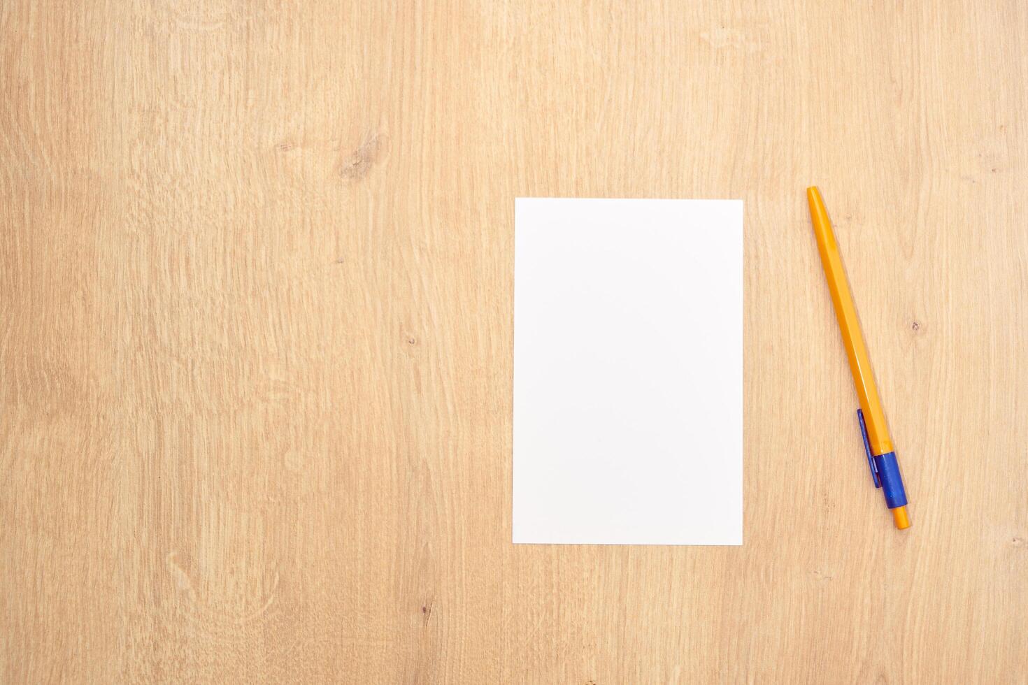 blank a 4 paper and a pen on a table photo