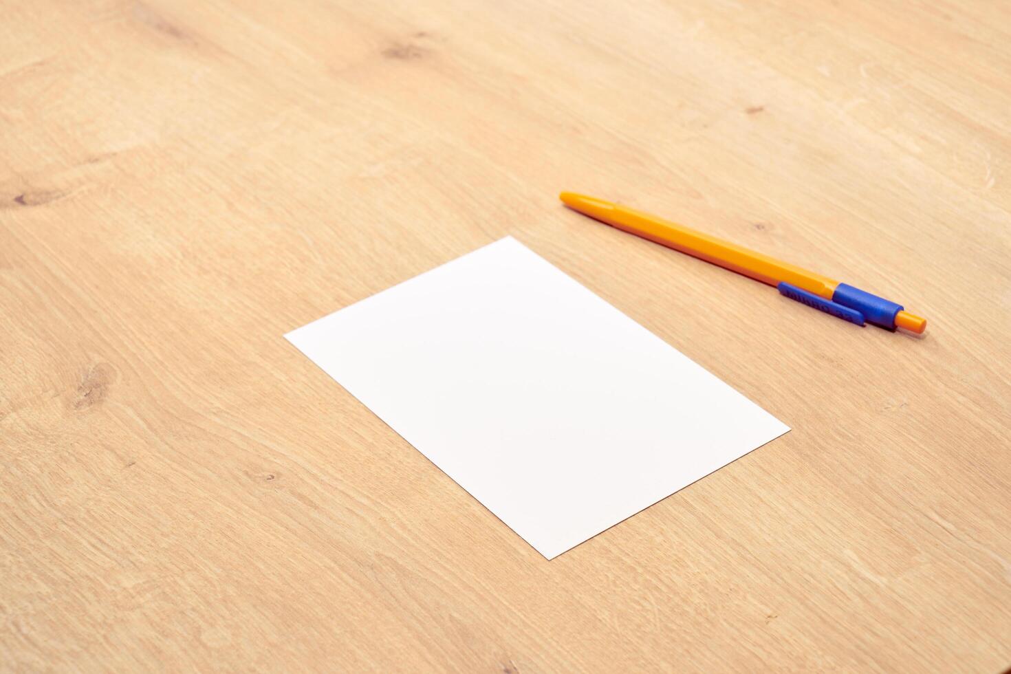 blank a 4 paper and a pen on a table photo