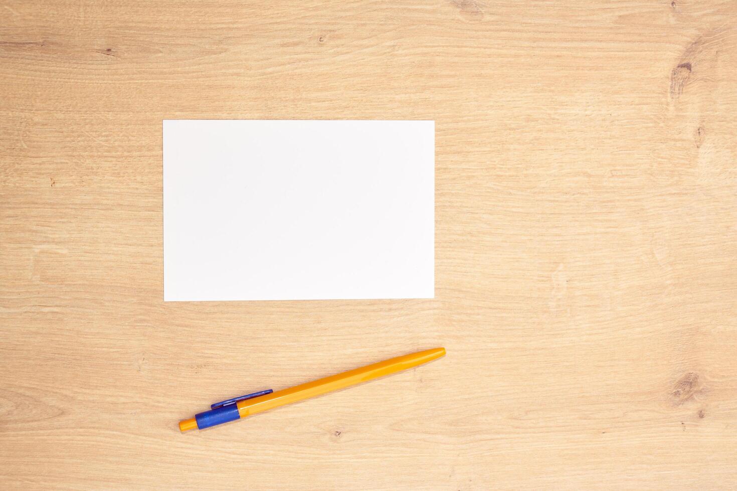 blank a 4 paper and a pen on a table photo