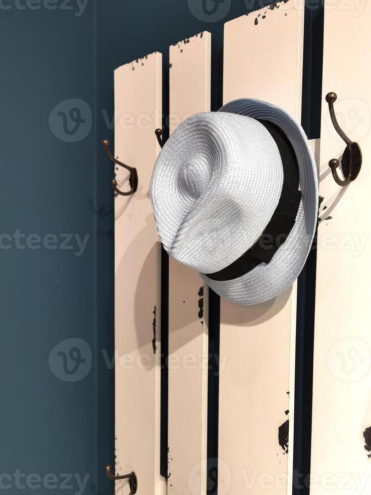 Old White hat on a hanger photo