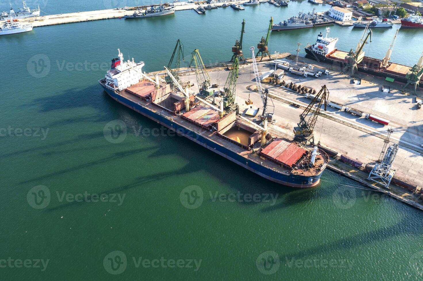 Aerial view from a drone of a large ship loading grain for export. Water transport photo