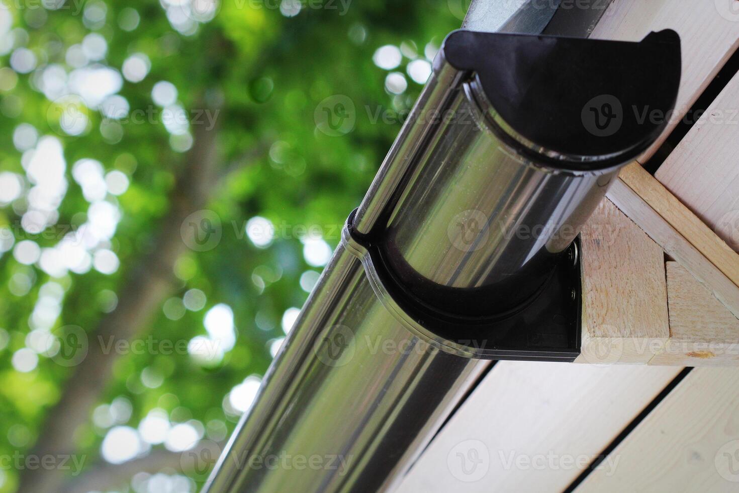 Rain Gutter Pipeline System Installation. Roofing Construction. Rain gutter system and roof protection from snow photo