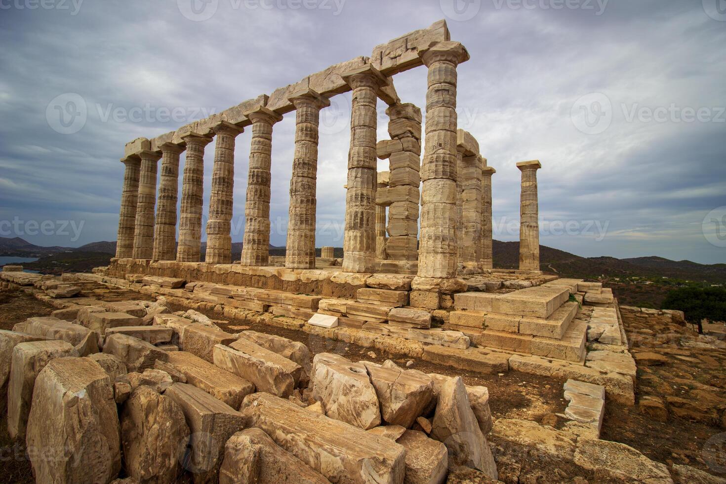 The ancient ruin of Poseidon, Cape of Sounion with cloudy weather near Athens, Greece. photo