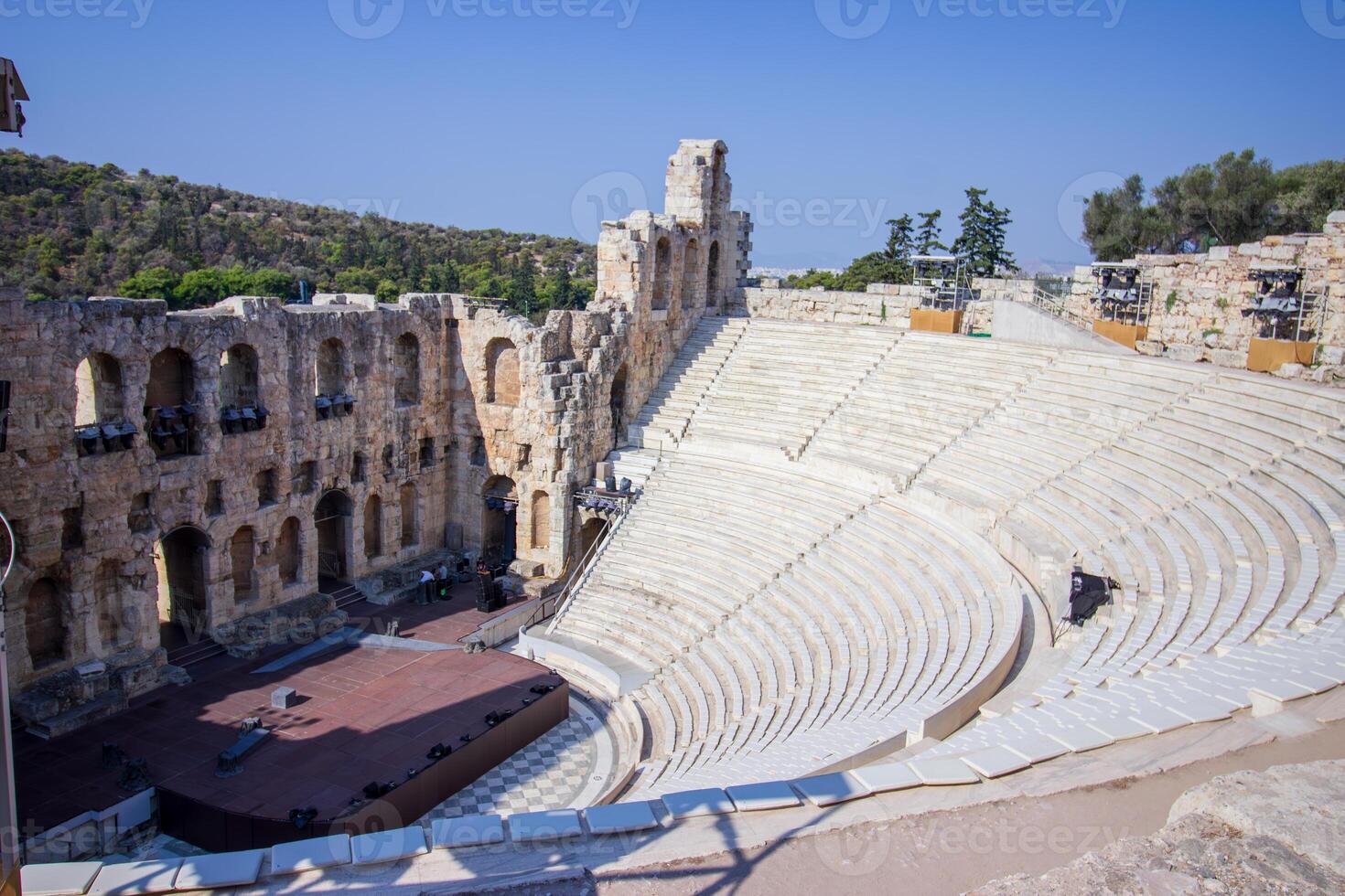 The ancient theatre of Dionysus on the slope of the Acropolis hill in Athens, Greece. View of the famous Dionysus Theatre on a sunny day with a beautiful sky. photo