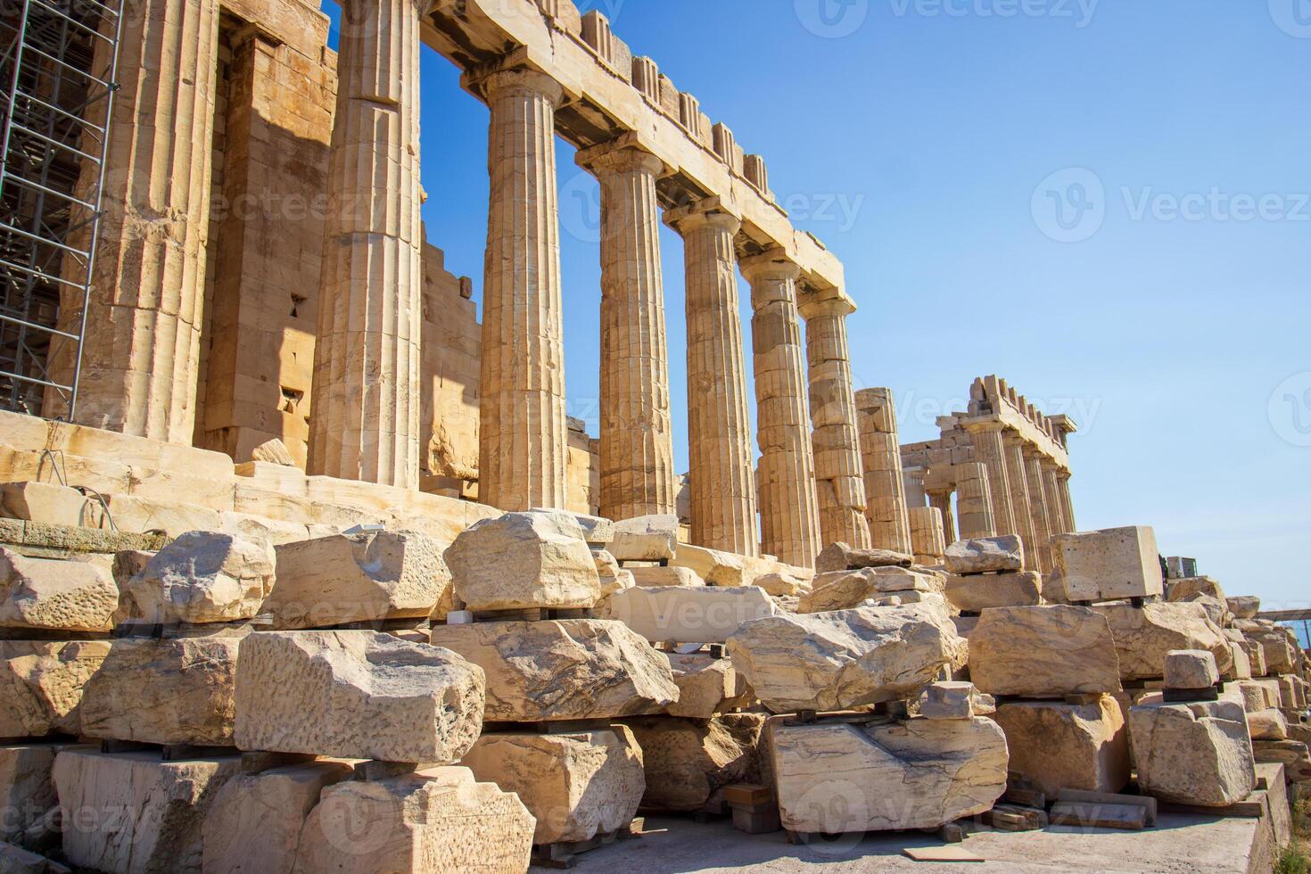 Ancient Parthenon Temple on top of the Acropolis Athens, Greece at sunny day with a blue sky. The landmark of Athens. Parthenon is the temple of for dedication to the goddess Athena. photo