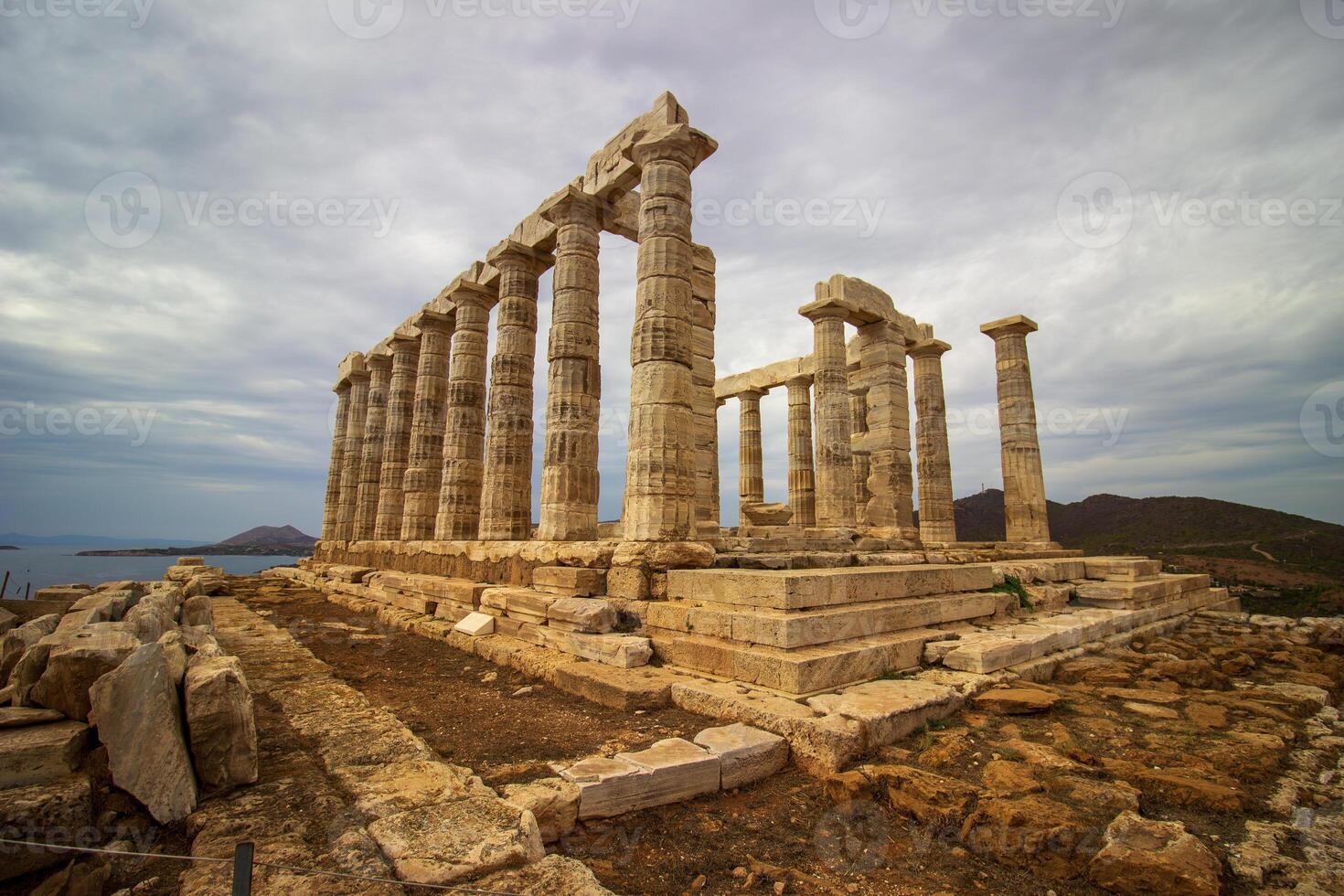 The ancient ruin of Poseidon, Cape of Sounion with cloudy weather near Athens, Greece. photo