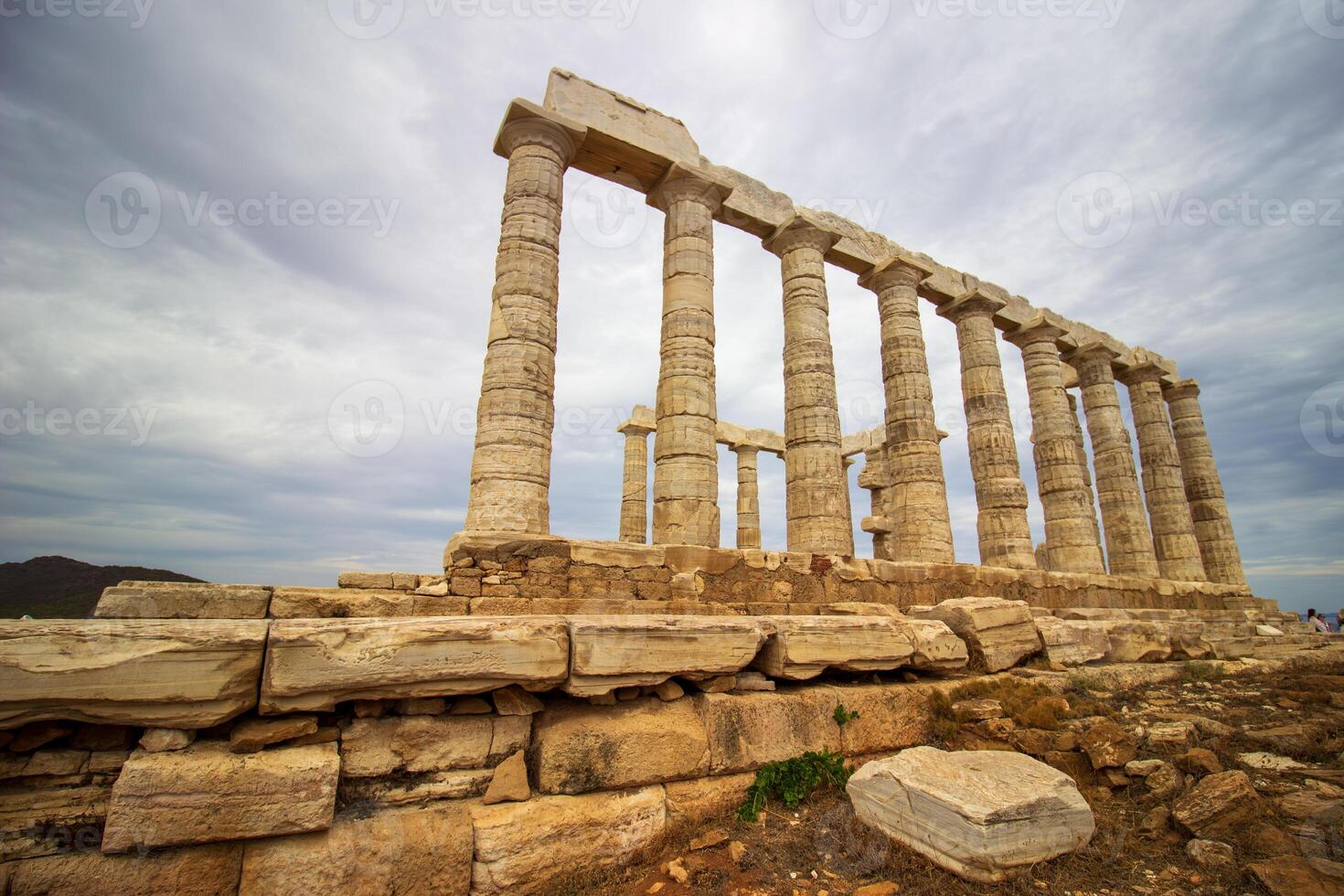 The ancient ruin of Poseidon, Cape of Sounion with cloudy weather near Athens, Greece. photo