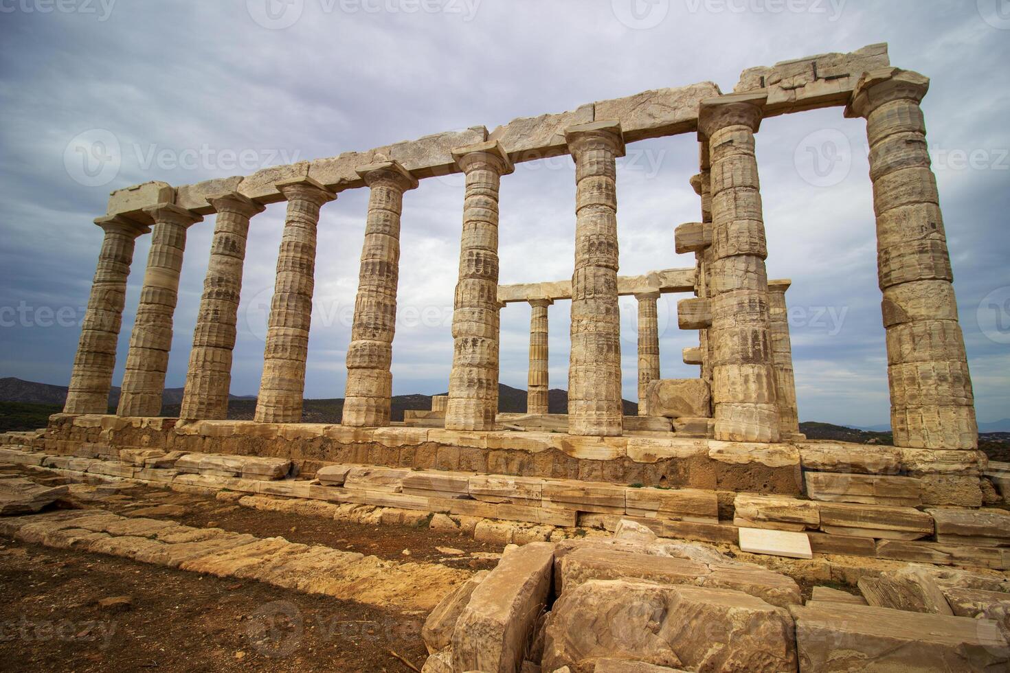 The ancient ruin of Poseidon, Cape of Sounion with cloudy weather near Athens, Greece. photo