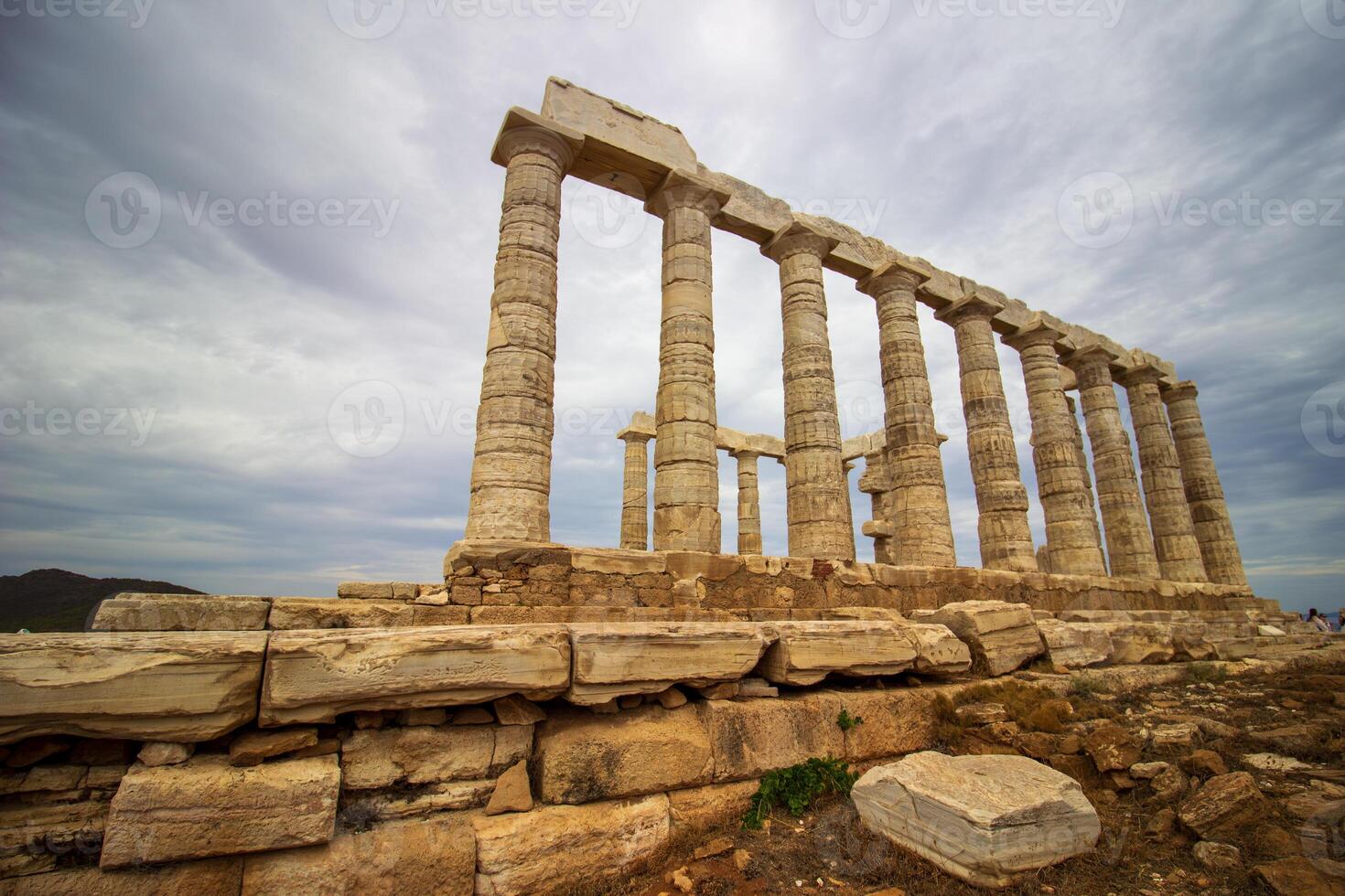 The ancient ruin of Poseidon, Cape of Sounion with cloudy weather near Athens, Greece. photo