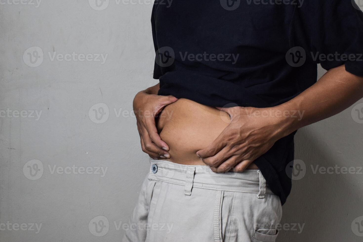 Man body fat belly. Obese Man with fat upset about her belly photo