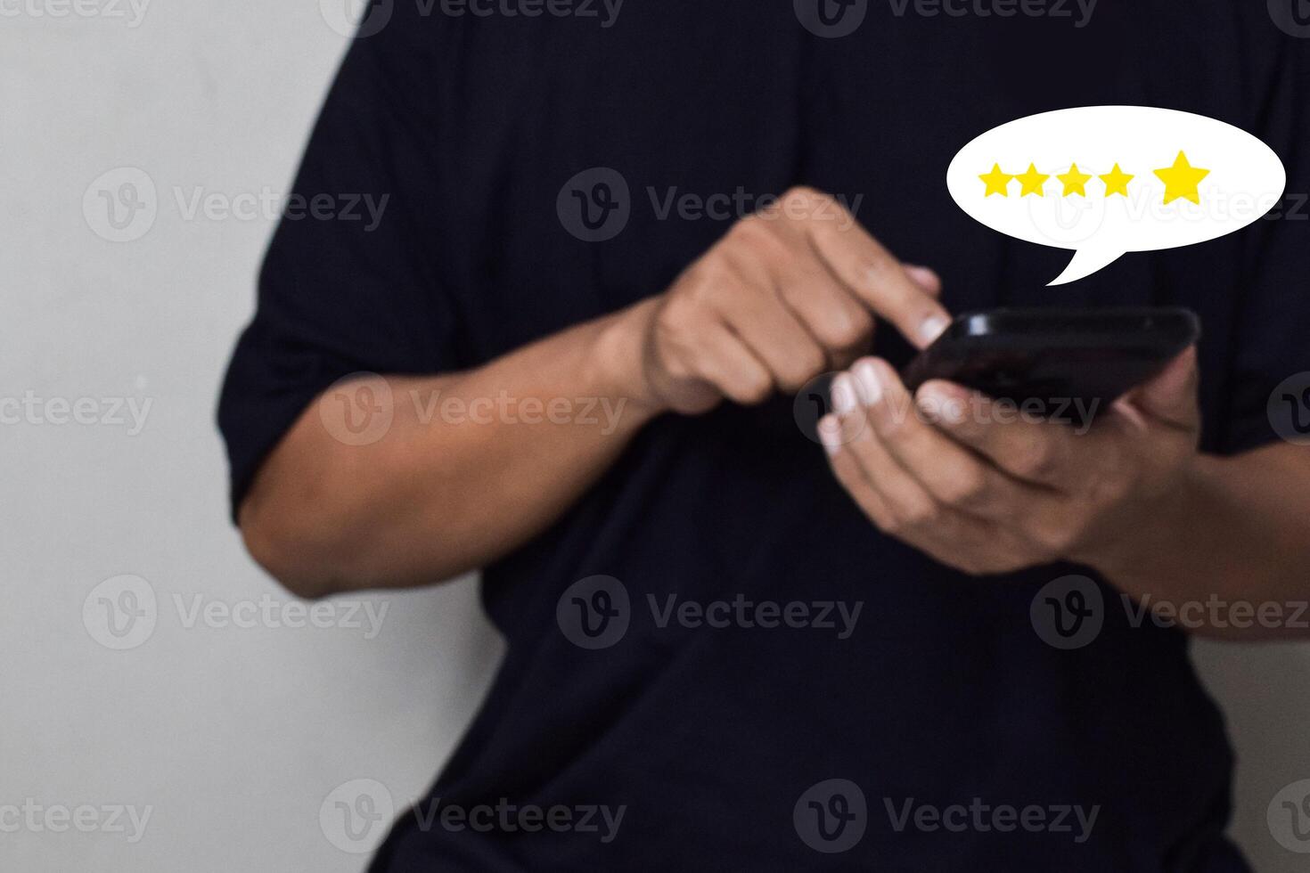 View of Customer hand pressing on smartphone screen with gold five star rating feedback icon photo