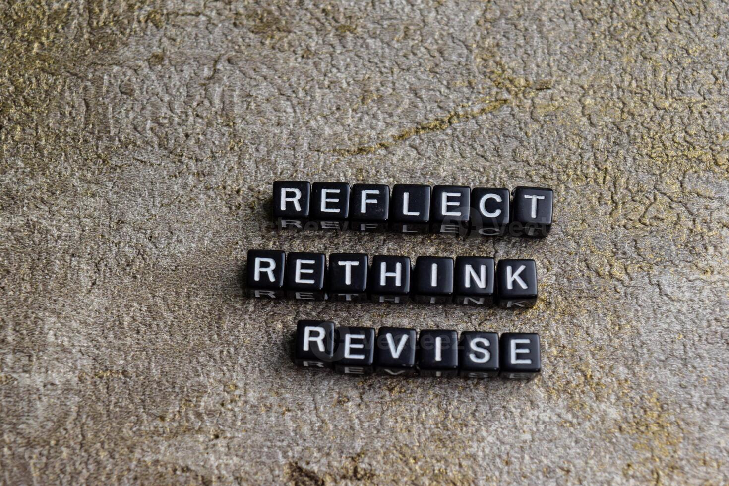 Concept of Reflect, Rethink, revise written on wooden blocks. Cross processed image on Wooden Background photo