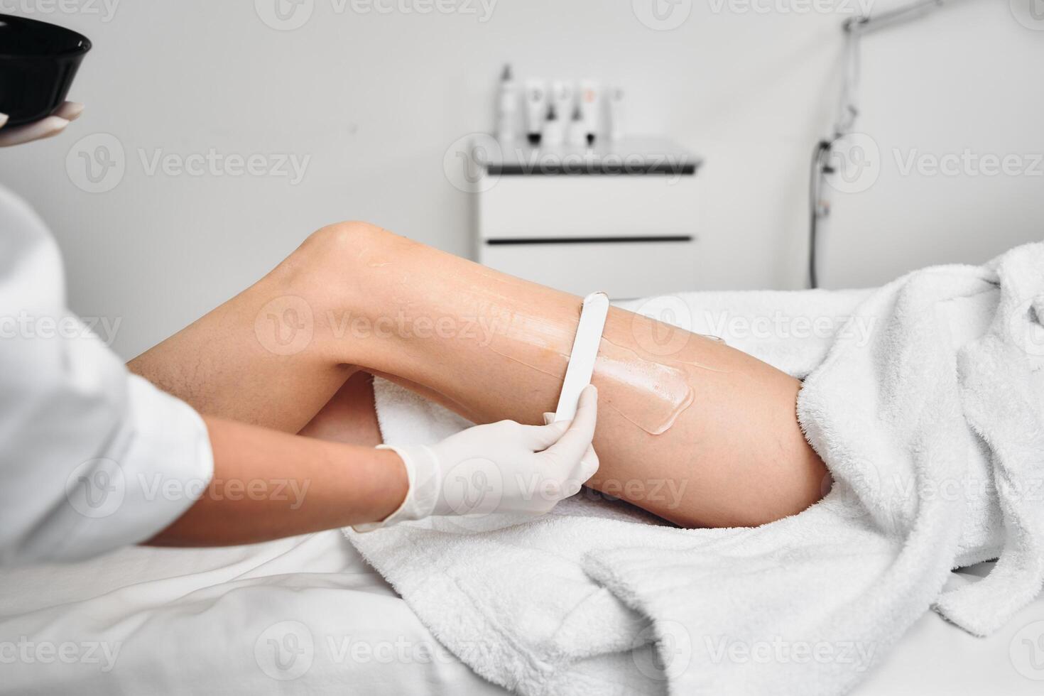 Laser epilation of legs in a beauty salon. photo