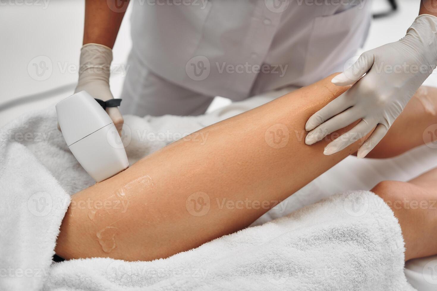 Laser epilation of legs in a beauty salon. photo