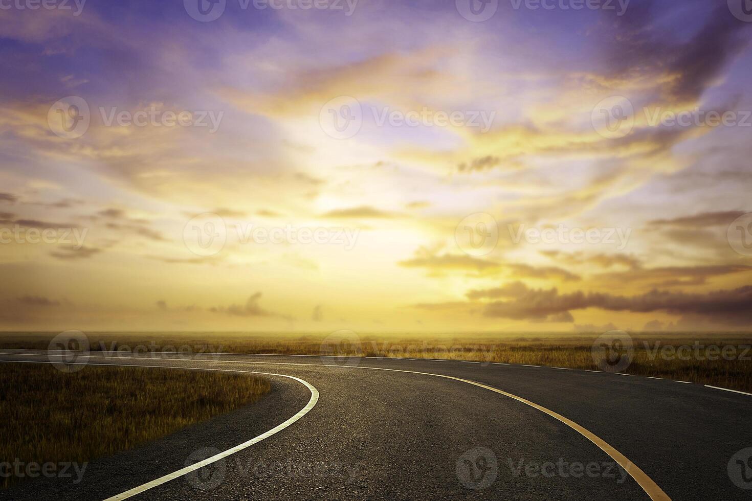 empty asphalt road and grassland at sunset photo
