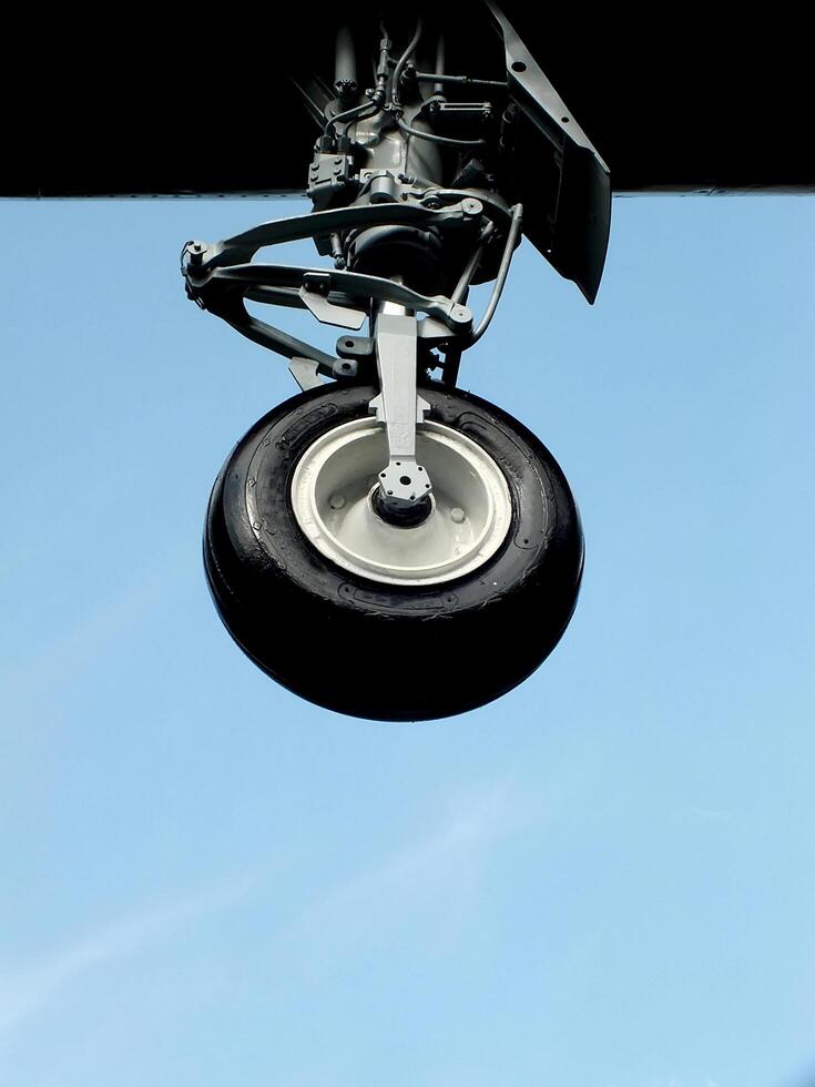 Close up of a landing gear of an airplane in the air. Airplane tire. Air transportation photo