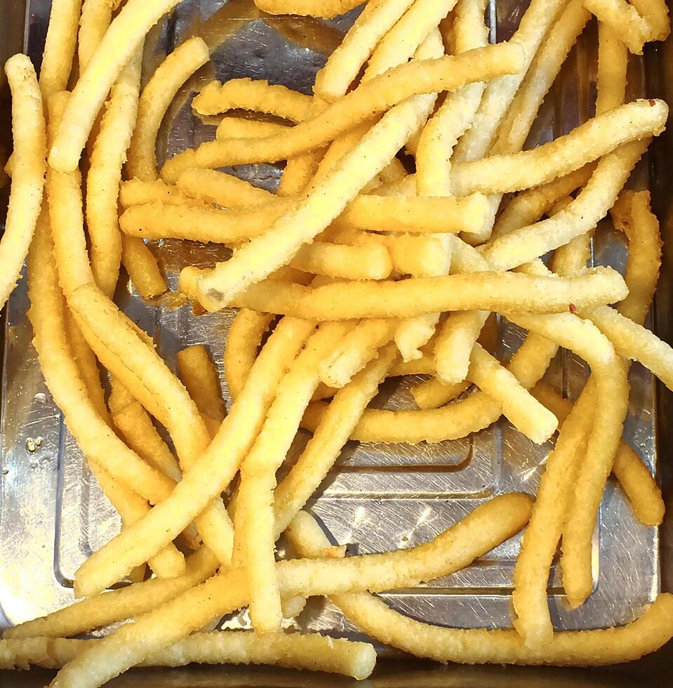 French fries or fried potatoes fresh from kitchen and ready for eat. Fast food to sell for hungry people. cafe or restaurant concept image idea photo