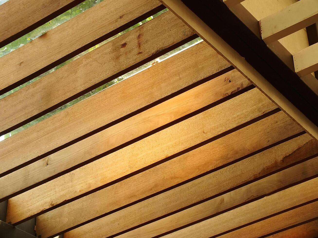 A timber roof truss with geometric wooden patterns. Architectural background concept housing photo