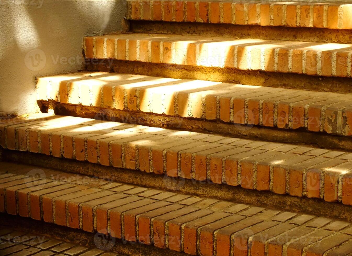Old red brick stairs with sun rays around it. Path way concept background with copy space for text photo