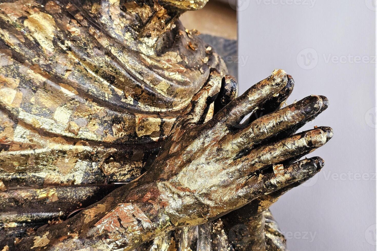 Close up Golden Hands of Monk Statue. photo