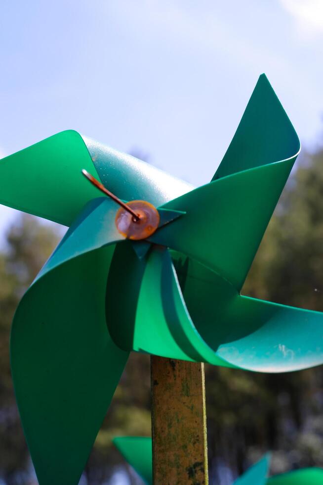 Close-up of plastic green Pinwheel in amusement park. Abstract Background of ornament in amusement park. Graphic Resources. Macro Photography. Travel Destinations. Holiday photography concept photo