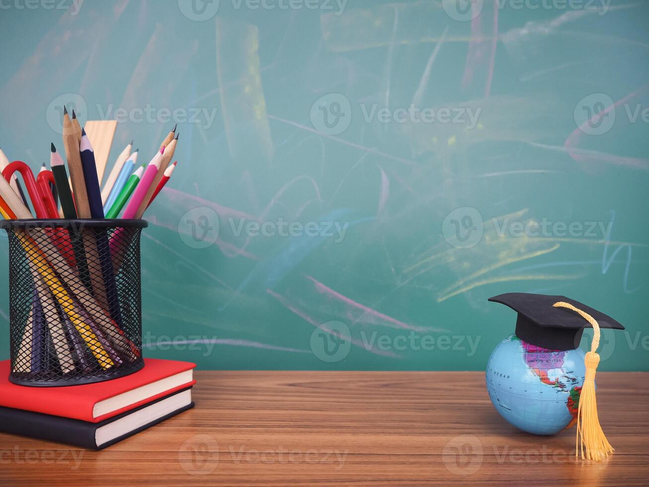 Student creative desktop, earth globe with graduation hat and colorful stationery on hardcover book. Copy space for text, Back to school, Education concept photo
