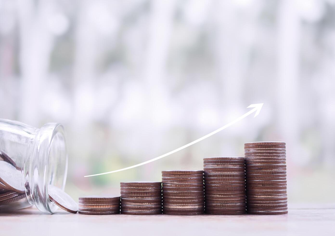 Stack of coins with arrow rising up. The concept of saving money, Financial, Investment and Business growing up. photo