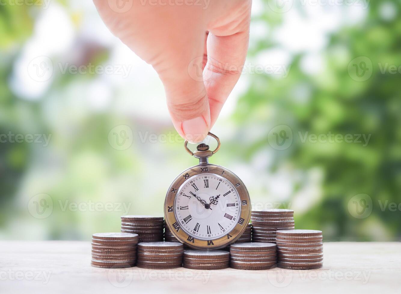 Vintage watch on stack of coins. The concept of saving money for manage time to success business. photo