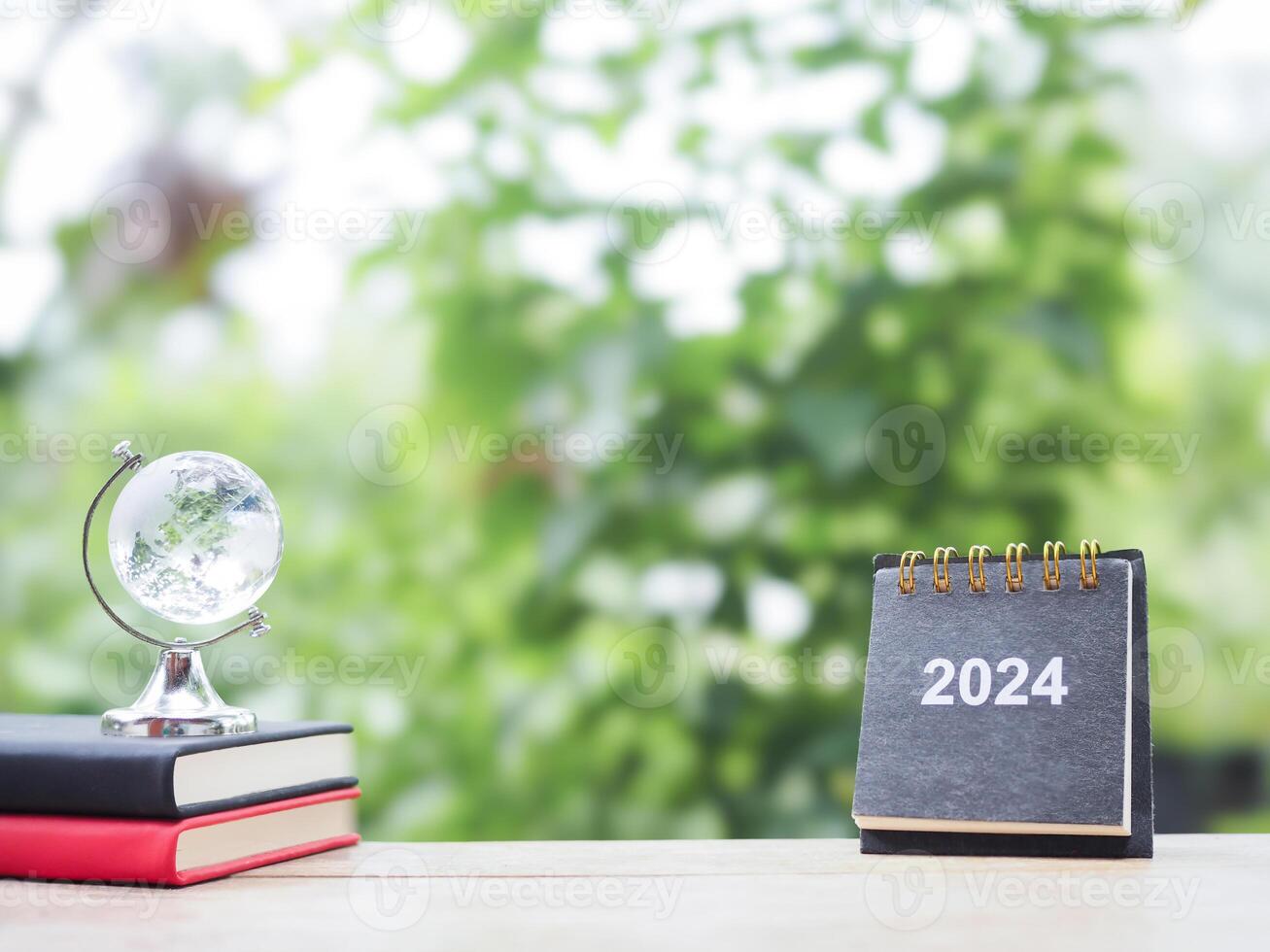 Student creative desktop , glass earth globe on hardcover book with desk calendar. Copy space for text, Back to school, Education concept photo
