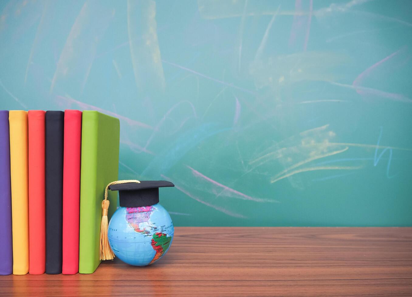 Student creative desktop , earth globe with graduation hat and hardcover book. Copy space for text, Back to school, Education concept photo